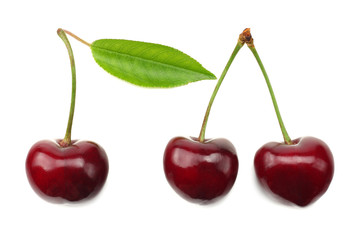 cherry with green leaf isolated on white background