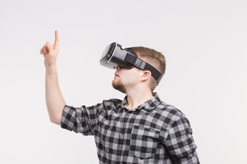 Man wearing virtual reality glasses raising his hand