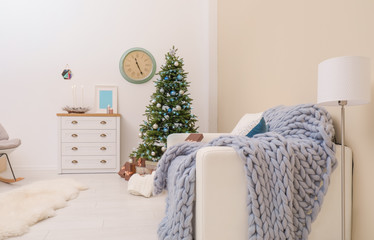 Stylish living room interior with decorated Christmas tree