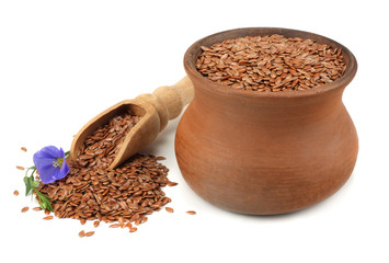 clay pot with flax seeds and flower isolated on white background. flaxseed or linseed. Cereals.