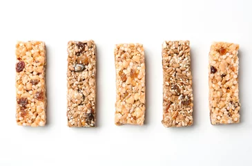 Poster Different grain cereal bars on white background. Healthy snack © New Africa