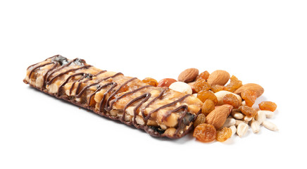 Grain cereal bar with chocolate, nuts and raisins on white background