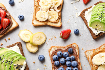 Tasty toast bread with fruits and berries on light background