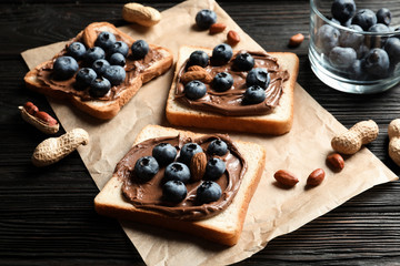 Toast bread with chocolate spread and blueberry on dark background