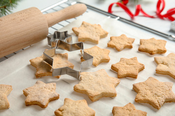 Fototapeta na wymiar Tasty homemade Christmas cookies on baking parchment