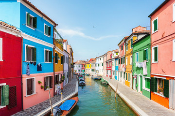 Naklejka na ściany i meble Street with colored houses on the island of Burano and with a canal in the middle, near Venice, Italy