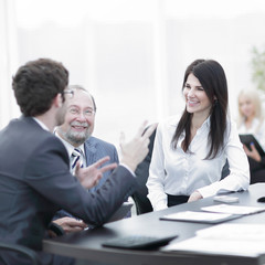 project Manager and staff talking at the Desk
