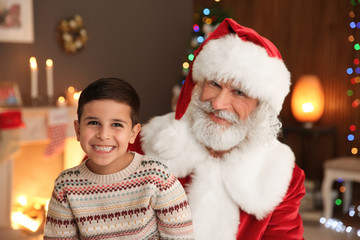 Portrait of little child with Santa Claus at home. Christmas celebration