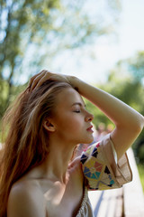 Portrait of a red-haired girl with long hair. Hair down. Artistic portrait. Child of nature....