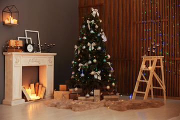 Stylish room interior with Christmas tree and decorative fireplace