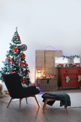 Stylish living room interior with decorated Christmas tree