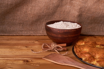 apricot pie and a bowl with flour and other ingredients and tools table