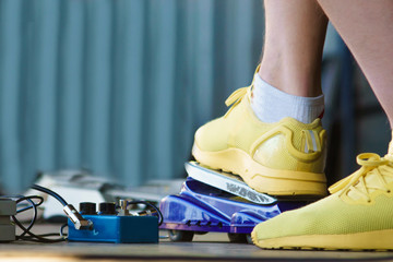 the guitarist switches the effects on the stage. concert in the open air