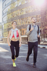 
young couple of runners on the street, healthy lifestyle concept