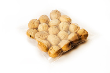 Fototapeta na wymiar walnuts packed in plastic bag isolated on white background