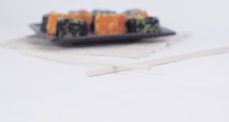 different types of Maki sushi on a black plate