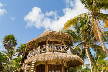 Eco hotel. A hut on the beach. Wooden house in the tropics. Beach house