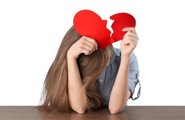 Woman ripping up a paper heart isolated