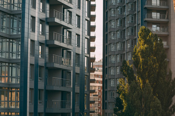 Fototapeta premium Bottom view of modern skyscrapers in business district against blue sky