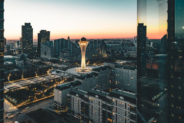 Night sunset sunrise view towards Bayterek tower and house of ministries in Nursultan Astana Kazakhstan on a clear day - obrazy, fototapety, plakaty
