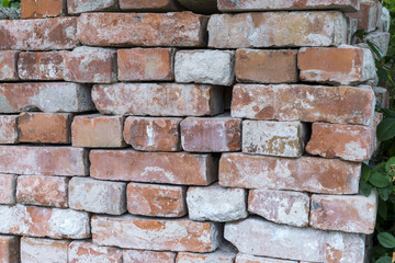 old loosely stacked bricks to a wall