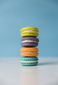 Close-up of colorful macaroons on table against blue background