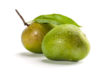Mangoes with stem and leaf isolated on white background