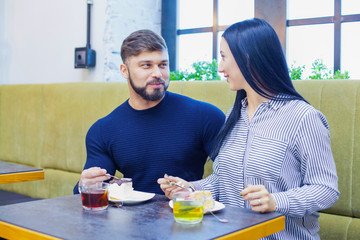 Happy loving couple enjoying breakfast in a cafe. Love, dating, food, lifestyle