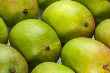 Raw Mangoes arranged on table top indoor