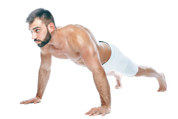 Push ups. bodybuilder posing. Beautiful sporty guy male power. Fitness muscled manin white lingerie. on isolated white background.
