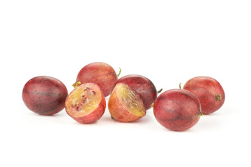 Group of five whole two halves of fresh red gooseberry hinnomaki variety isolated on white