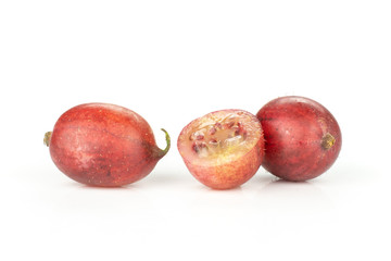 Group of two whole one half of fresh red gooseberry hinnomaki variety isolated on white