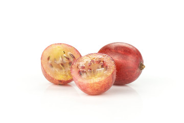 Group of one whole two halves of fresh red gooseberry hinnomaki variety isolated on white