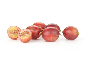 Group of five whole two halves of fresh red gooseberry hinnomaki variety isolated on white