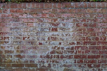 Old stained red brick wall