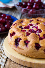 Cherry cake and fresh summer berries on rustic table