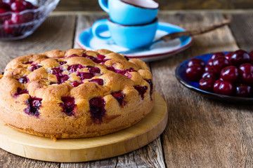 Cherry cake and fresh summer berries on rustic table