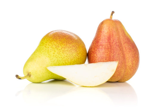 Group of two whole one slice of fresh red pear forelle variety isolated on white