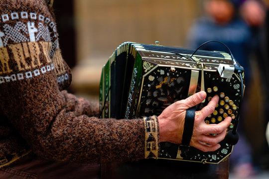 Close-up of street bandoneon player playing tango