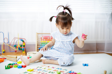 baby girl learning alphabet at home