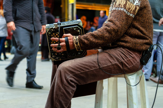 Close-up of street bandoneon player playing tango