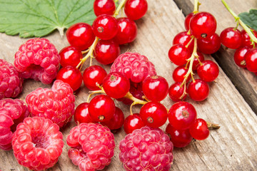 Red berries on an old board. Summer background.