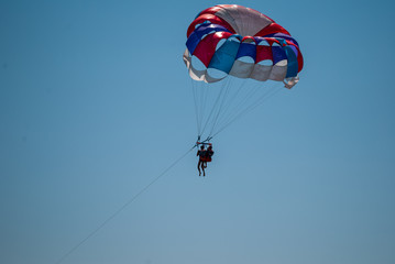 parasailing on a parachute fly two people