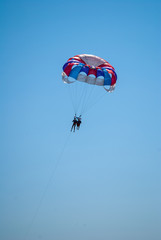 parasailing on a parachute fly two people