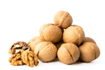 Pile of walnut in a shell and peeled on a white, isolated.