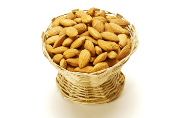 Almonds in Cane basket isolated on white background