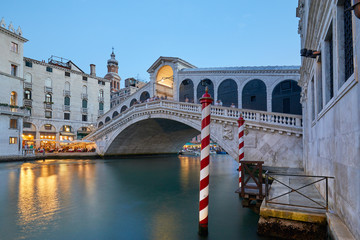 The Grand Canal and Rialto bridge with people, evening in Venice, Italy