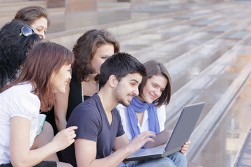 Fototapeta premium friends of the students looking at the laptop screen