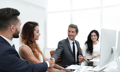 handshake colleagues at a working meeting
