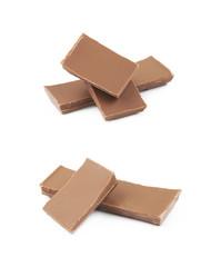 Pile of milk chocolate pieces isolated